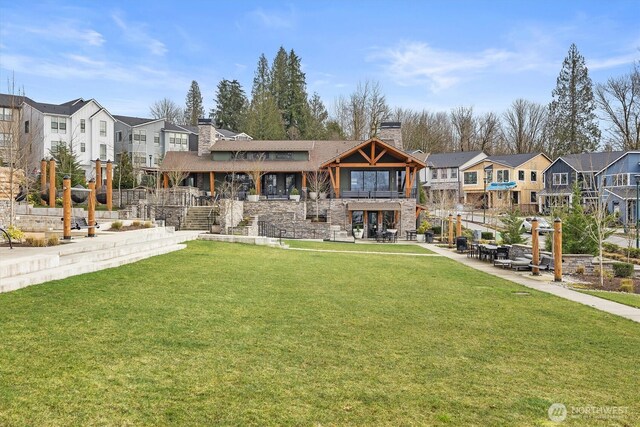 26627 NE Boyd Way Unit 101, Duvall, WA 98019 - view of front of house with a chimney, a residential view, a front yard, and stone siding