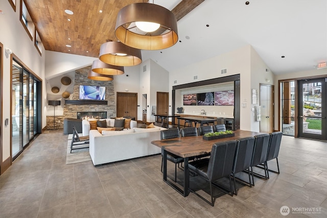 26627 NE Boyd Way Unit 101, Duvall, WA 98019 - living room featuring high vaulted ceiling, wooden ceiling, a stone fireplace, and recessed lighting