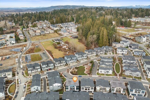 26627 NE Boyd Way Unit 101, Duvall, WA 98019 - aerial view of property and surrounding area with nearby suburban area, mountains, and a heavily wooded area