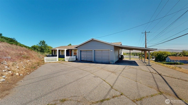 504 Ash St N, Omak, WA 98841 - view of front of property featuring driveway, a carport, and a garage