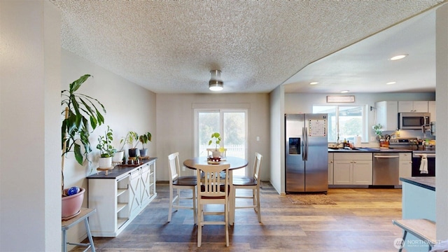 504 Ash St N, Omak, WA 98841 - dining room with a textured ceiling, plenty of natural light, light wood-type flooring, and recessed lighting