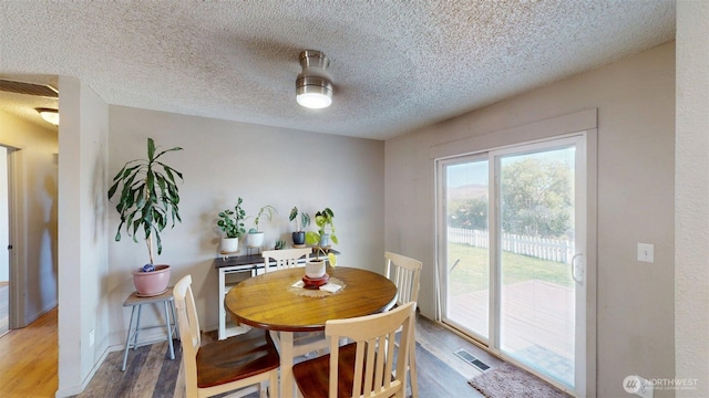 504 Ash St N, Omak, WA 98841 - dining area featuring wood finished floors and a textured ceiling