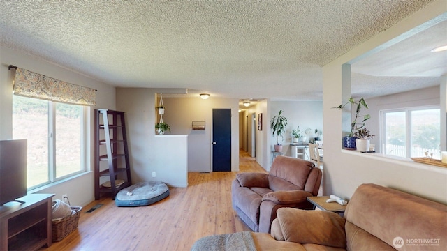 504 Ash St N, Omak, WA 98841 - living area featuring plenty of natural light, a textured ceiling, and wood finished floors