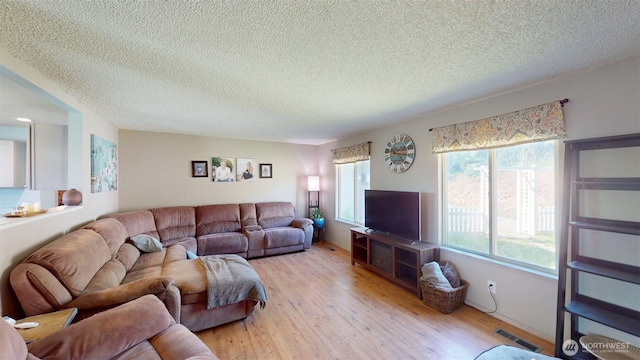 504 Ash St N, Omak, WA 98841 - living room featuring a textured ceiling and light wood-style floors