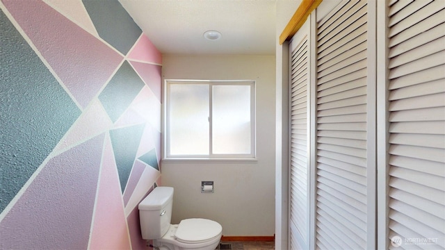 504 Ash St N, Omak, WA 98841 - bathroom featuring a closet, toilet, and baseboards
