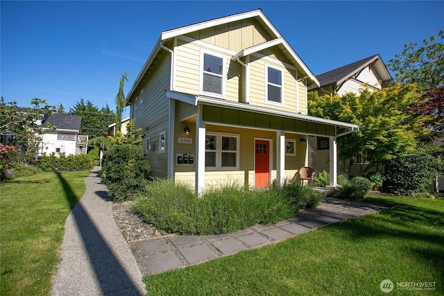 2730-2734 Nevada St, Bellingham, WA 98226 - view of front of property with board and batten siding, a porch, and a front lawn
