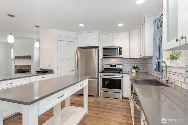 2730-2734 Nevada St, Bellingham, WA 98226 - kitchen featuring appliances with stainless steel finishes, a sink, tasteful backsplash, white cabinetry, and dark countertops