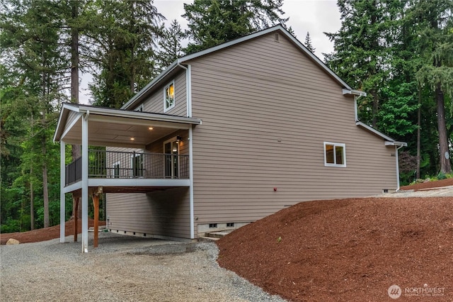 31823 44th Ave S, Auburn, WA 98001 - view of side of home featuring a balcony, crawl space, and gravel driveway