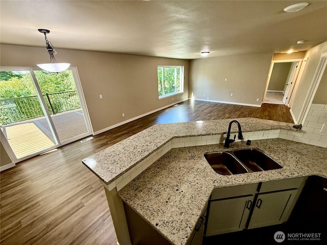 31823 44th Ave S, Auburn, WA 98001 - kitchen with a sink, wood finished floors, open floor plan, decorative backsplash, and decorative light fixtures