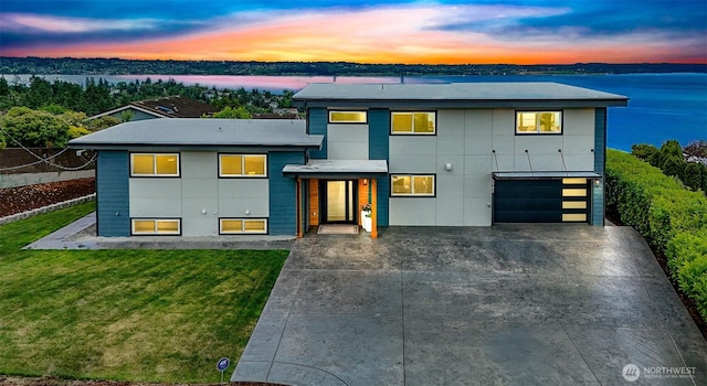 5942 Beverly Ave NE, Tacoma, WA 98422 - contemporary home featuring driveway, a garage, a lawn, and a water view