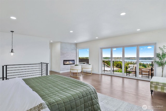 5942 Beverly Ave NE, Tacoma, WA 98422 - bedroom with access to outside, wood finished floors, recessed lighting, a water view, and baseboards