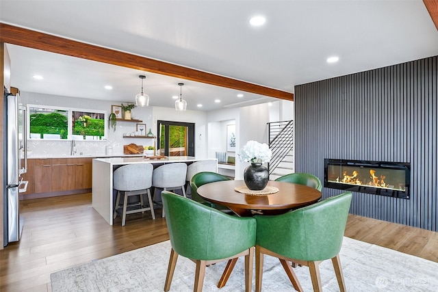 5942 Beverly Ave NE, Tacoma, WA 98422 - dining space with beam ceiling, light wood-style flooring, recessed lighting, and a glass covered fireplace