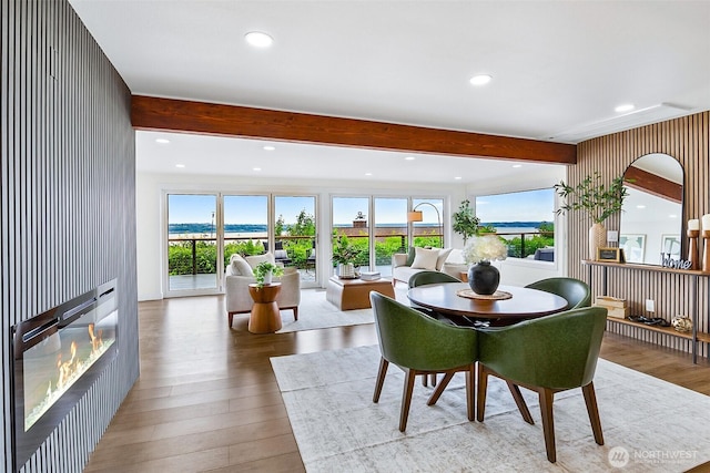 5942 Beverly Ave NE, Tacoma, WA 98422 - dining area featuring wood finished floors, plenty of natural light, beam ceiling, recessed lighting, and a glass covered fireplace