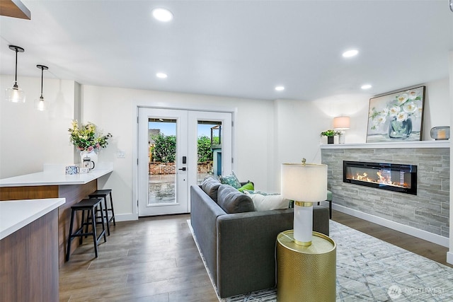 5942 Beverly Ave NE, Tacoma, WA 98422 - living room with a glass covered fireplace, wood finished floors, french doors, baseboards, and recessed lighting