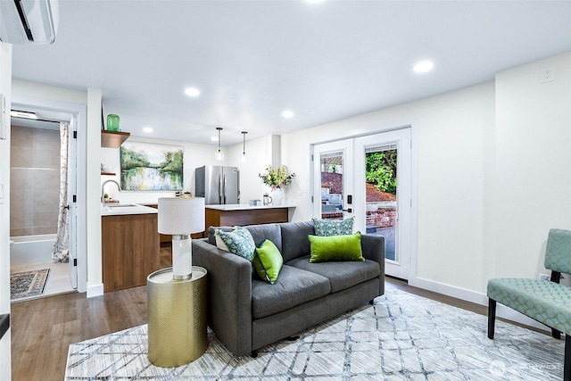 5942 Beverly Ave NE, Tacoma, WA 98422 - living area with a wall mounted AC, light wood-style flooring, recessed lighting, and baseboards