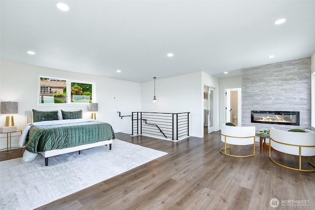5942 Beverly Ave NE, Tacoma, WA 98422 - bedroom featuring wood finished floors, recessed lighting, and a large fireplace