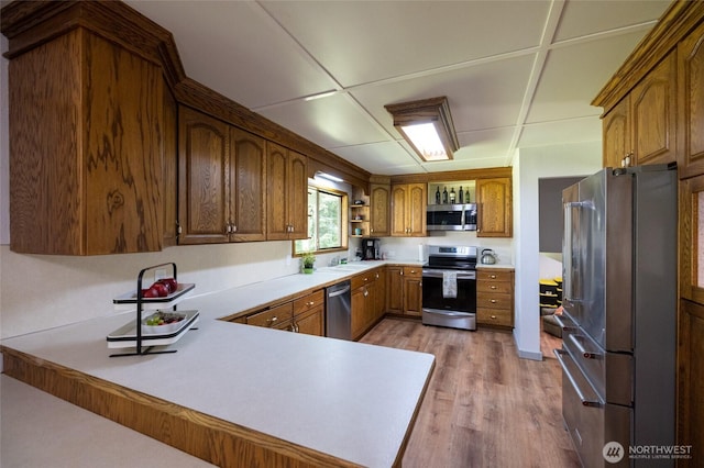 371 Pigeon Springs Rd, Onalaska, WA 98570 - kitchen with appliances with stainless steel finishes, light wood-type flooring, a sink, light countertops, and open shelves