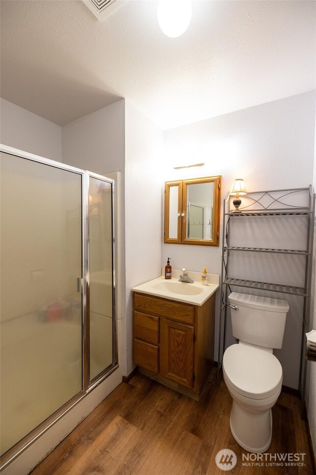 371 Pigeon Springs Rd, Onalaska, WA 98570 - bathroom with wood finished floors, vanity, toilet, and a shower stall