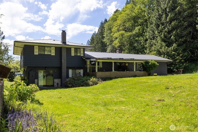 371 Pigeon Springs Rd, Onalaska, WA 98570 - back of property with a standing seam roof, a chimney, a yard, and metal roof