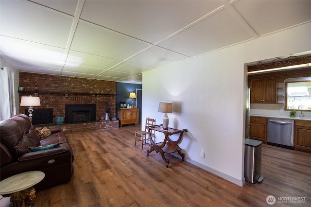 371 Pigeon Springs Rd, Onalaska, WA 98570 - living room with dark wood finished floors, a brick fireplace, and baseboards