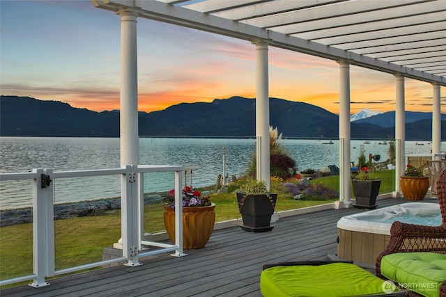 10903 Samish Beach Ln, Bow, WA 98232 - deck at dusk with a pergola and a water and mountain view