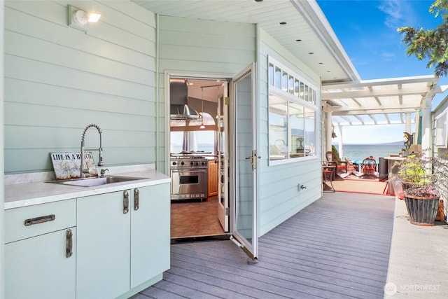 10903 Samish Beach Ln, Bow, WA 98232 - wooden deck featuring a sink, a pergola, and a water view