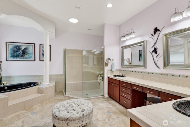 10903 Samish Beach Ln, Bow, WA 98232 - bathroom featuring ornate columns, vanity, a stall shower, a garden tub, and decorative backsplash