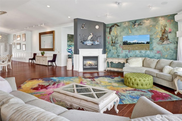 10903 Samish Beach Ln, Bow, WA 98232 - living area with wood finished floors, track lighting, a glass covered fireplace, and a wainscoted wall