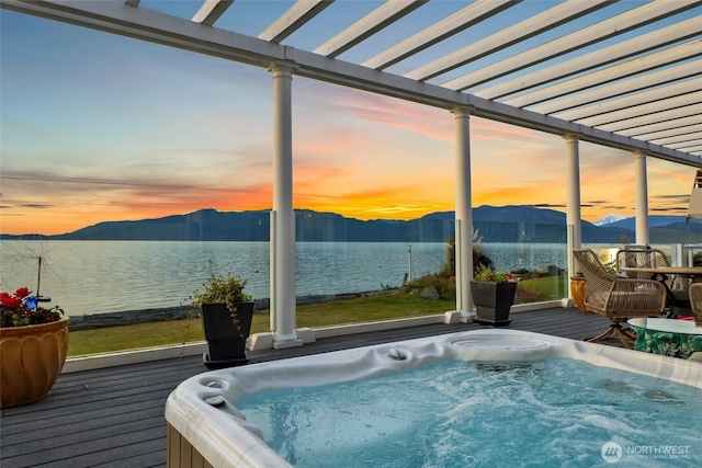 10903 Samish Beach Ln, Bow, WA 98232 - pool at dusk with a hot tub, a deck with water view, and a pergola