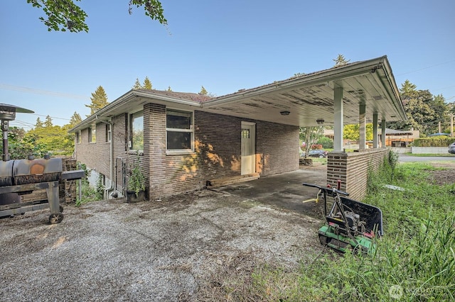 1001 Fairway Dr, Fircrest, WA 98466 - view of side of home with a carport and brick siding