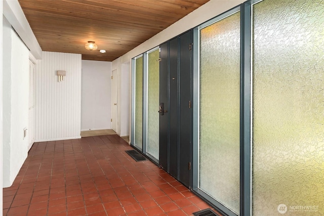 7633 NE 123rd St, Kirkland, WA 98034 - hallway with wooden ceiling and dark tile patterned flooring