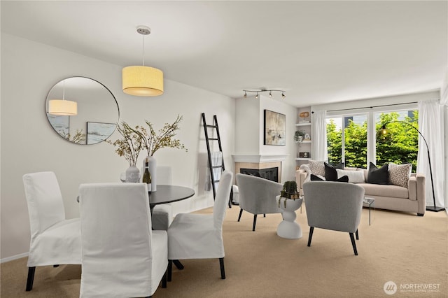 1400 Taylor Ave N Unit 203, Seattle, WA 98109 - dining area featuring light colored carpet and a fireplace
