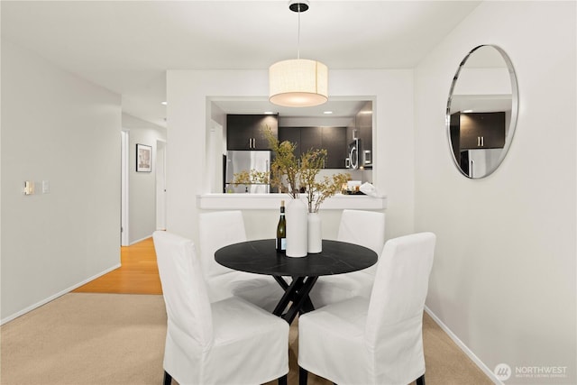 1400 Taylor Ave N Unit 203, Seattle, WA 98109 - dining space featuring baseboards and light colored carpet