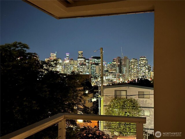 1400 Taylor Ave N Unit 203, Seattle, WA 98109 - balcony at twilight featuring a view of city lights