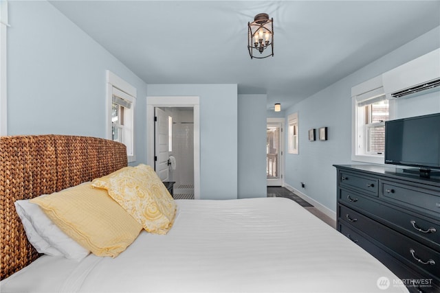 33 N Glen Ln, Pacific Beach, WA 98571 - bedroom with a wall mounted AC, baseboards, a chandelier, and wood finished floors