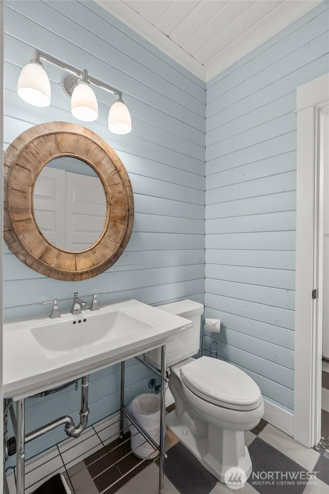 33 N Glen Ln, Pacific Beach, WA 98571 - bathroom featuring wooden walls, toilet, and a sink