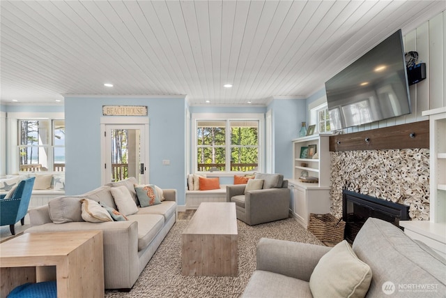 33 N Glen Ln, Pacific Beach, WA 98571 - living room with healthy amount of natural light, a glass covered fireplace, ornamental molding, wooden ceiling, and recessed lighting