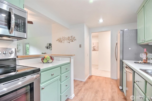 22002 SE 40th Ln Unit 1111, Issaquah, WA 98029 - kitchen featuring stainless steel appliances, green cabinetry, light wood-style flooring, light countertops, and recessed lighting