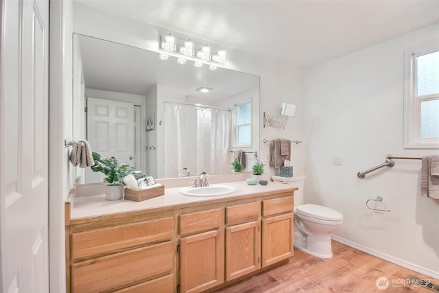 22002 SE 40th Ln Unit 1111, Issaquah, WA 98029 - full bathroom with vanity, toilet, wood finished floors, and a shower with shower curtain