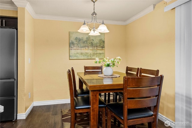 23410 18th Ave S Unit A102, Des Moines, WA 98198 - dining space featuring dark wood-style flooring, baseboards, crown molding, and a chandelier