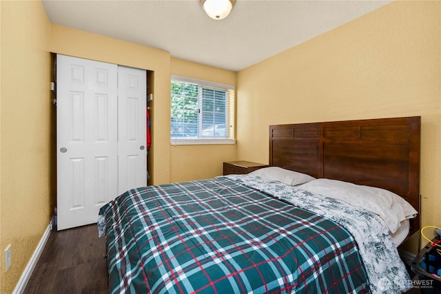 23410 18th Ave S Unit A102, Des Moines, WA 98198 - bedroom featuring wood finished floors, baseboards, and a closet