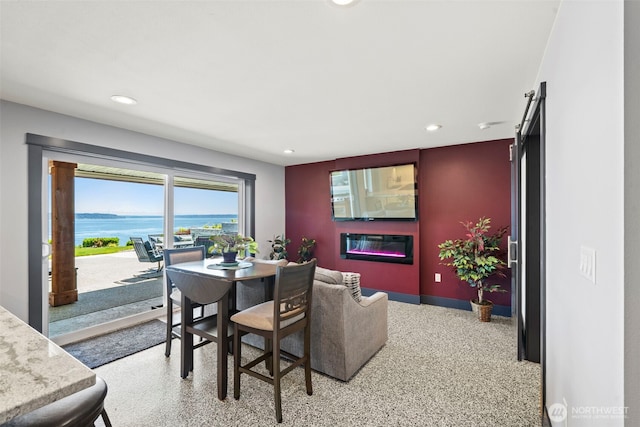 8210 Walnut Rd NE, Olympia, WA 98516 - dining room featuring recessed lighting, dark aggregate flooring, baseboards, and a glass covered fireplace