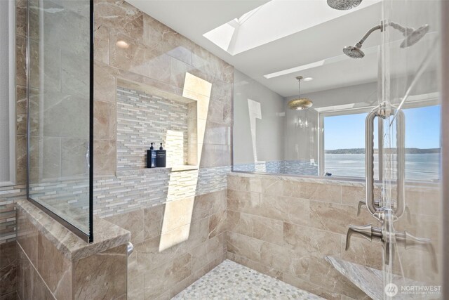 8210 Walnut Rd NE, Olympia, WA 98516 - full bathroom with a skylight, tiled shower, tile walls, and a water view