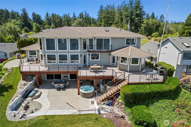 8210 Walnut Rd NE, Olympia, WA 98516 - rear view of house featuring a hot tub, a balcony, a wooden deck, a patio, and outdoor dining area
