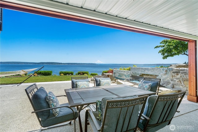 8210 Walnut Rd NE, Olympia, WA 98516 - view of patio featuring outdoor dining area and a water view