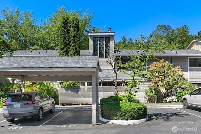 9930 NE 144th Ln Unit 206, Kirkland, WA 98034 - view of building exterior featuring covered and uncovered parking