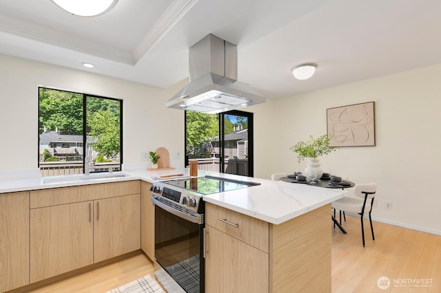 9930 NE 144th Ln Unit 206, Kirkland, WA 98034 - kitchen with electric range, island exhaust hood, light brown cabinetry, a peninsula, and light wood-style flooring