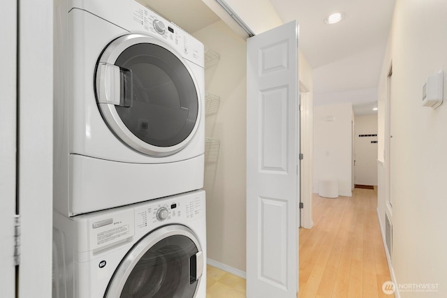 9930 NE 144th Ln Unit 206, Kirkland, WA 98034 - laundry room featuring stacked washer / dryer, recessed lighting, baseboards, and light wood-type flooring