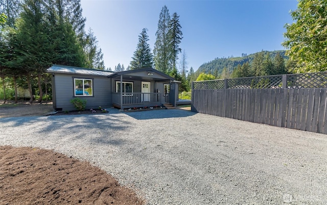 20215 Crystal Springs Dr, Granite Falls, WA 98252 - view of front facade with covered porch, metal roof, and gravel driveway