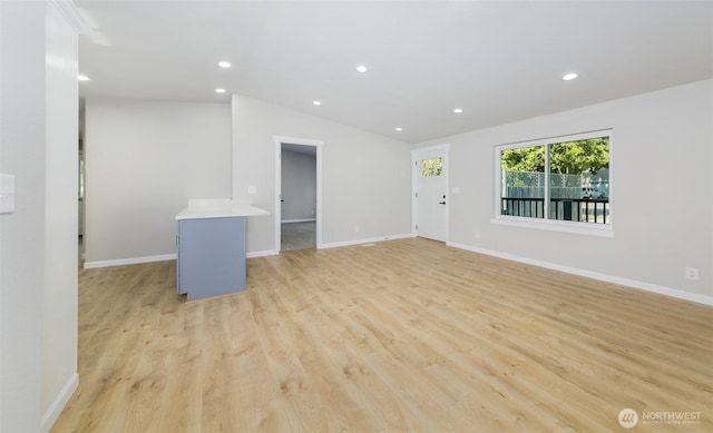 20215 Crystal Springs Dr, Granite Falls, WA 98252 - unfurnished living room featuring recessed lighting, vaulted ceiling, light wood-type flooring, and baseboards